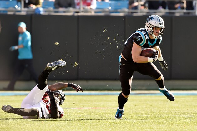 CHARLOTTE, NORTH CAROLINA - DECEMBER 23: Christian McCaffrey #22 of the Carolina Panthers runs the ball against Deion Jones #45 of the Atlanta Falcons in the first quarter during their game at Bank of America Stadium on December 23, 2018 in Charlotte, North Carolina. (Photo by Grant Halverson/Getty Images)
