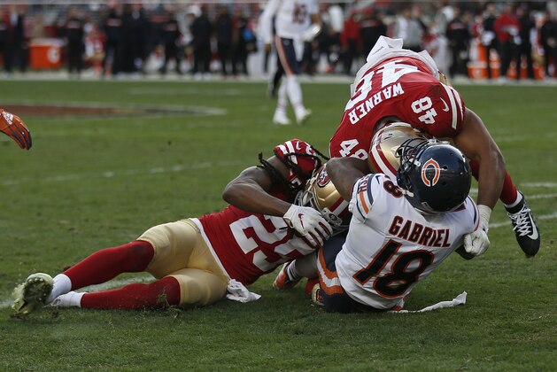 Chicago Bears wide receiver Taylor Gabriel (18) is tackled by San Francisco 49ers defensive back Richard Sherman (25) and linebacker Fred Warner (48) during the second half of an NFL football game in Santa Clara, Calif., Sunday, Dec. 23, 2018. (AP Photo/D. Ross Cameron)