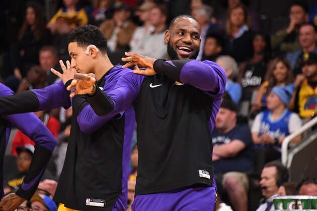 SAN JOSE, CA - OCTOBER 12: LeBron James #23 of the Los Angeles Lakers celebrates a three point basket on the bench during a pre-season game against the Golden State Warriors on October 12, 2018 at the SAP Center in San Jose, California. NOTE TO USER: User expressly acknowledges and agrees that, by downloading and/or using this Photograph, user is consenting to the terms and conditions of the Getty Images License Agreement. Mandatory Copyright Notice: Copyright 2018 NBAE (Photo by Andrew D. Bernstein/NBAE via Getty Images)