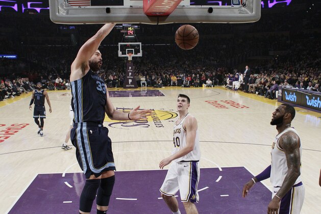 Memphis Grizzlies' Marc Gasol, left, dunks next to Los Angeles Lakers' Ivica Zubac, center, and LeBron James during the first half of an NBA basketball game, Sunday, Dec. 23, 2018, in Los Angeles. (AP Photo/Marcio Jose Sanchez)