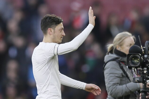 Arsenal's Mesut Ozil waves to his fans after the English Premier League soccer match between Arsenal and Burnley at the Emirates Stadium in London, Saturday, Dec. 22, 2018. (AP Photo/Tim Ireland)