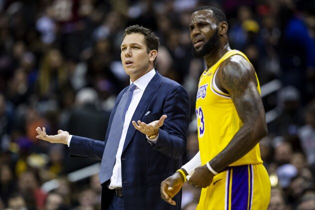 Los Angeles Lakers forward LeBron James (23) and head coach Luke Walton dispute a call during the first half of an NBA basketball game against the Washington Wizards, Sunday, Dec. 16, 2018, in Washington. (AP Photo/Al Drago)