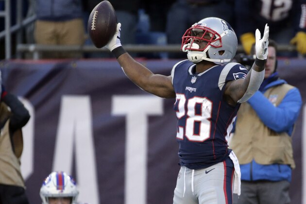 New England Patriots running back James White, right, celebrates his touchdown run as Buffalo Bills safety Micah Hyde (23) sits on the turf during the first half of an NFL football game, Sunday, Dec. 23, 2018, in Foxborough, Mass. (AP Photo/Elise Amendola)