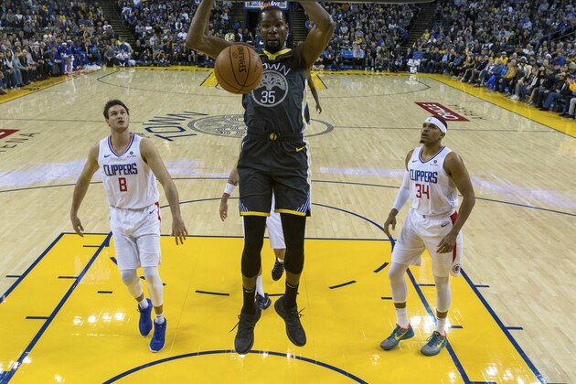Golden State Warriors forward Kevin Durant (35) dunks the ball as Los Angeles Clippers forward Danilo Gallinari (8) and forward Tobias Harris (34) watch in the first quarter of an NBA basketball game, Sunday, Dec. 23, 2018, in Oakland, Calif. (AP Photo/John Hefti)