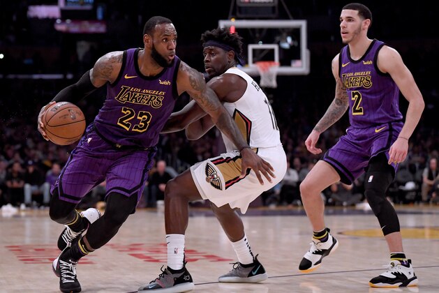 LOS ANGELES, CALIFORNIA - DECEMBER 21: LeBron James #23 of the Los Angeles Lakers drives to the basket on Jrue Holiday #11 of the New Orleans Pelicans after a screen from Lonzo Ball #2 during a 112-104 Laker win at Staples Center on December 21, 2018 in Los Angeles, California. NOTE TO USER: User expressly acknowledges and agrees that, by downloading and or using this photograph, User is consenting to the terms and conditions of the Getty Images License Agreement. (Photo by Harry How/Getty Images) LOS ANGELES, CALIFORNIA - DECEMBER 21: LeBron James #23 of the Los Angeles Lakers drives to the basket on Jrue Holiday #11 of the New Orleans Pelicans after a screen from Lonzo Ball #2 during a 112-104 Laker win at Staples Center on December 21, 2018 in Los Angeles, California. NOTE TO USER: User expressly acknowledges and agrees that, by downloading and or using this photograph, User is consenting to the terms and conditions of the Getty Images License Agreement. (Photo by Harry How/Getty Images)