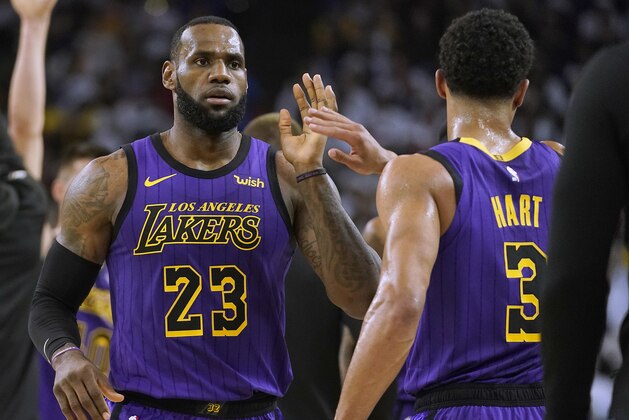 Los Angeles Lakers forward LeBron James (23) high-fives Josh Hart (3) at the end of the first half of the team's NBA basketball game against the Golden State Warriors on Tuesday, Dec. 25, 2018, in Oakland, Calif. (AP Photo/Tony Avelar)