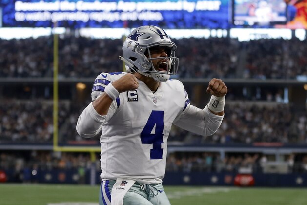 Dallas Cowboys quarterback Dak Prescott (4) celebrates scoring a touchdown on a running play in the first half of an NFL football game against the Tampa Bay Buccaneers in Arlington, Texas, Sunday, Dec. 23, 2018. (AP Photo/Ron Jenkins)