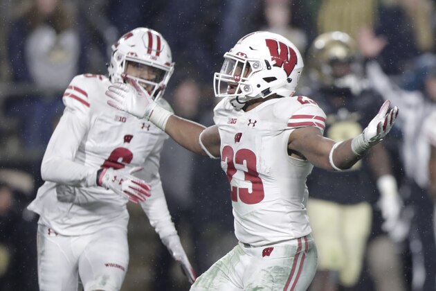 Wisconsin running back Jonathan Taylor (23) celebrates his game-winning touchdown against Purdue during overtime of an NCAA college football game in West Lafayette, Ind., Saturday, Nov. 17, 2018. Wisconsin defeated Purdue 47-44 in overtime. (AP Photo/Michael Conroy)