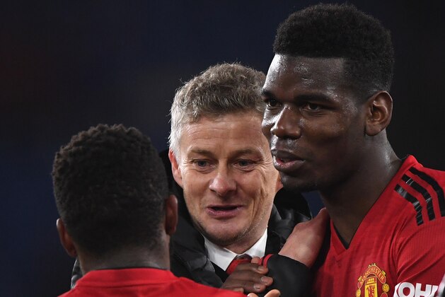 CARDIFF, WALES - DECEMBER 22:  Ole Gunnar Solskjaer, Interim Manager of Manchester United celebrates with Fred and Paul Pogba after the Premier League match between Cardiff City and Manchester United at Cardiff City Stadium on December 22, 2018 in Cardiff, United Kingdom.  (Photo by Stu Forster/Getty Images)