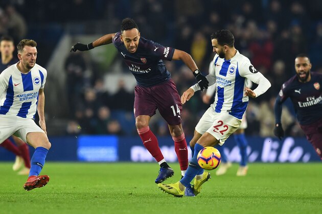 Arsenal's Gabonese striker Pierre-Emerick Aubameyang (CL) is challenged by Brighton's Spanish defender Martin Montoya (CR) during the English Premier League football match between Brighton and Hove Albion and Arsenal at the American Express Community Stadium in Brighton, southern England on December 26, 2018. (Photo by Glyn KIRK / AFP) / RESTRICTED TO EDITORIAL USE. No use with unauthorized audio, video, data, fixture lists, club/league logos or 'live' services. Online in-match use limited to 120 images. An additional 40 images may be used in extra time. No video emulation. Social media in-match use limited to 120 images. An additional 40 images may be used in extra time. No use in betting publications, games or single club/league/player publications. /         (Photo credit should read GLYN KIRK/AFP/Getty Images)