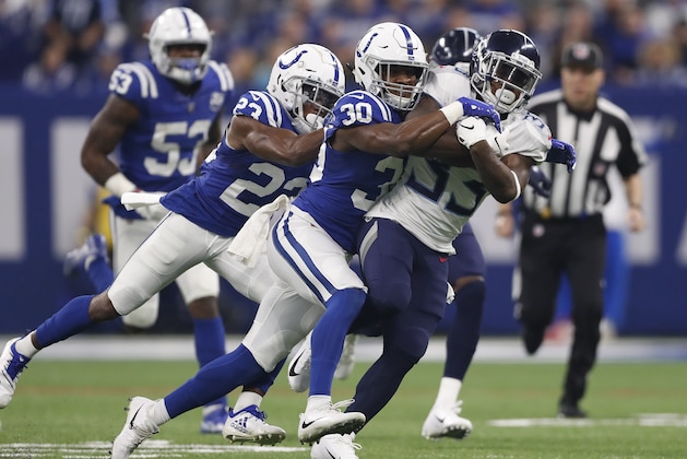 Tennessee Titans' Dion Lewis (33) is talked by Indianapolis Colts' George Odum (30) during the first half of an NFL football game Sunday, Nov. 18, 2018, in Indianapolis. (AP Photo/Jeff Roberson)