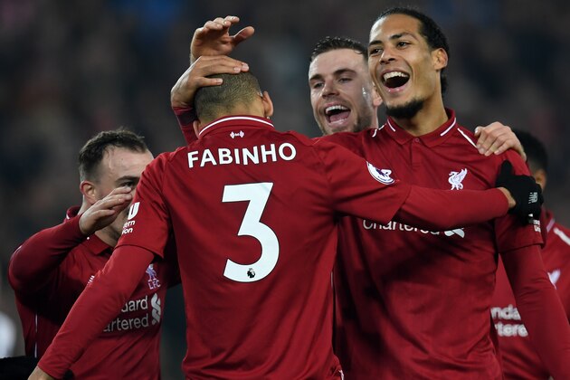 Liverpool's Brazilian midfielder Fabinho (C) celebrates with teammates after scoring their fourth goal during the English Premier League football match between Liverpool and Newcastle United at Anfield in Liverpool, north west England on December 26, 2018. - Liverpool won the game 4-0. (Photo by Paul ELLIS / AFP) / RESTRICTED TO EDITORIAL USE. No use with unauthorized audio, video, data, fixture lists, club/league logos or 'live' services. Online in-match use limited to 120 images. An additional 40 images may be used in extra time. No video emulation. Social media in-match use limited to 120 images. An additional 40 images may be used in extra time. No use in betting publications, games or single club/league/player publications. /         (Photo credit should read PAUL ELLIS/AFP/Getty Images)