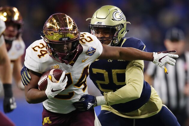 DETROIT, MICHIGAN - DECEMBER 26:  Mohamed Ibrahim #24 of the Minnesota Golden Gophers battles for yards during a first half run while being tackled by Tariq Carpenter #29 of the Georgia Tech Yellow Jackets during the Quick Lane Bowl at Ford Field on December 26, 2018 in Detroit, Michigan. (Photo by Gregory Shamus/Getty Images)