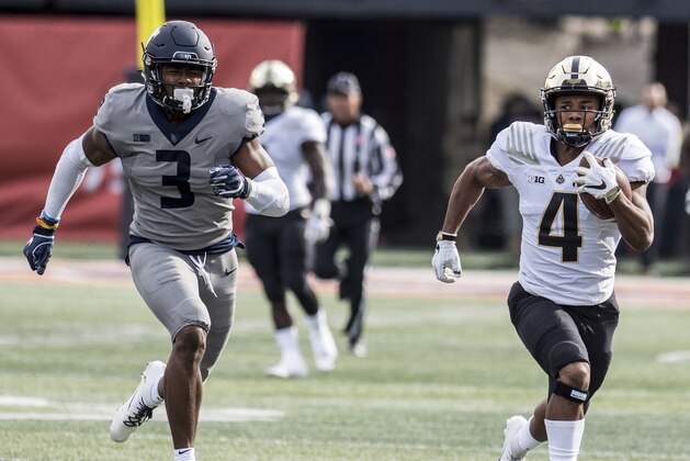 Purdue running back Rondale Moore (4) heads to the end zone pursued by Illinois' Del'Shawn Phillips (3) in the first half of a college NCAA football game between Illinois and Purdue, Saturday, Oct. 13, 2018, in Champaign, Ill. (AP Photo/Holly Hart)