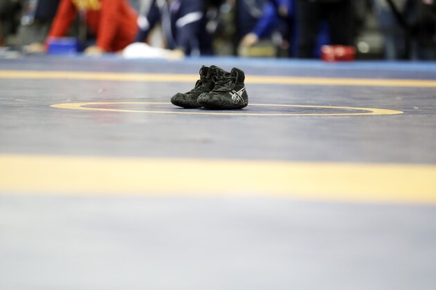 Spenser Mango's shoes sit on the center of the mat after losing to Jesse Thielke in their 59-kilogram Greco Roman match at the U.S. Olympic Wrestling Team Trials, Saturday, April 9, 2016, in Iowa City, Iowa. (AP Photo/Charlie Neibergall)