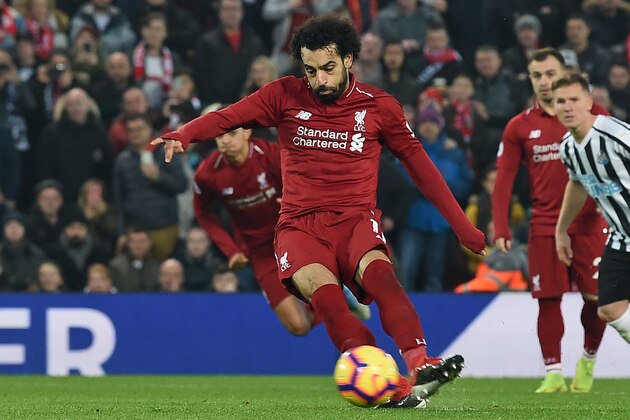 Liverpool's Egyptian midfielder Mohamed Salah shoots to score their second goal from the penalty spot during the English Premier League football match between Liverpool and Newcastle United at Anfield in Liverpool, north west England on December 26, 2018. (Photo by Paul ELLIS / AFP) / RESTRICTED TO EDITORIAL USE. No use with unauthorized audio, video, data, fixture lists, club/league logos or 'live' services. Online in-match use limited to 120 images. An additional 40 images may be used in extra time. No video emulation. Social media in-match use limited to 120 images. An additional 40 images may be used in extra time. No use in betting publications, games or single club/league/player publications. /         (Photo credit should read PAUL ELLIS/AFP/Getty Images)