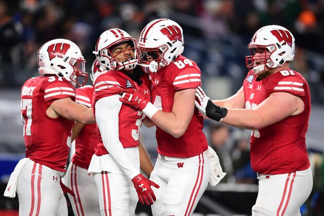 NEW YORK, NEW YORK - DECEMBER 27: The Wisconsin Badgers congratulate Kendric Pryor #3 of the Wisconsin Badgers after he scored a touchdown on the first drive in the first quarter of the New Era Pinstripe Bowl against the Miami Hurricanes at Yankee Stadium on December 27, 2018 in the Bronx borough of New York City. (Photo by Sarah Stier/Getty Images)