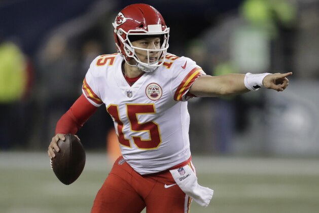 Kansas City Chiefs quarterback Patrick Mahomes scrambles with the ball during the second half of an NFL football game against the Seattle Seahawks, Sunday, Dec. 23, 2018, in Seattle. (AP Photo/Stephen Brashear)