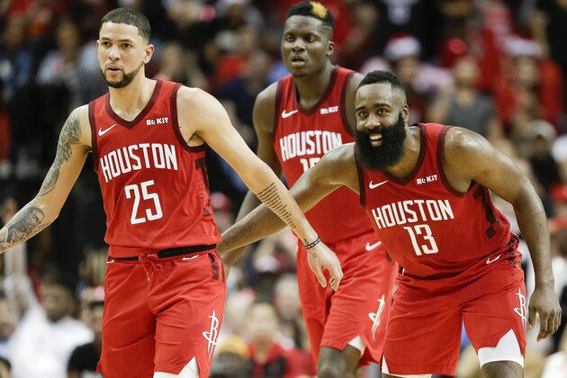 Houston Rockets guard James Harden (13) congratulates guard Austin Rivers (25) after Rivers' three-point basket late in the second half of an NBA basketball game against the Oklahoma City Thunder, Tuesday, Dec. 25, 2018, in Houston. Houston won 113-109. (AP Photo/Eric Christian Smith)