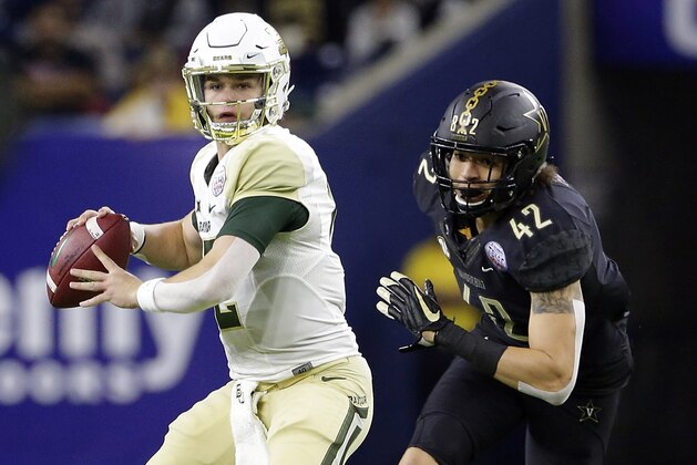 Baylor quarterback Charlie Brewer (12) looks to pass the ball as Vanderbilt linebacker Kenny Hebert (42) closes in during the first half of the Texas Bowl NCAA college football game Thursday, Dec. 27, 2018, in Houston. (AP Photo/Michael Wyke)