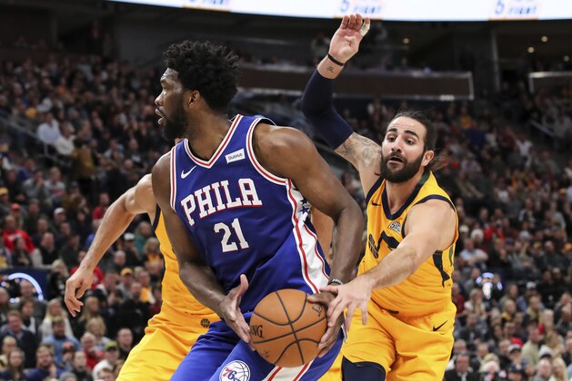 Utah Jazz guard Ricky Rubio tries to steal the ball from Philadelphia 76ers center Joel Embiid (21) during the second quarter of an NBA basketball game Thursday, Dec. 27, 2018, in Salt Lake City. (AP Photo/Chris Nicoll)