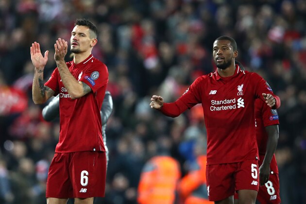 LIVERPOOL, ENGLAND - DECEMBER 11:  Fabinho, Dejan Lovren and Georginio Wijnaldum of Liverpool celebrate after the UEFA Champions League Group C match between Liverpool and SSC Napoli at Anfield on December 11, 2018 in Liverpool, United Kingdom.  (Photo by Clive Brunskill/Getty Images)