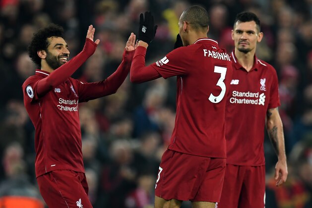 Liverpool's Brazilian midfielder Fabinho (C) celebrates with Liverpool's Egyptian midfielder Mohamed Salah (L) and Liverpool's Croatian defender Dejan Lovren (R) after he scores their fourth goal during the English Premier League football match between Liverpool and Newcastle United at Anfield in Liverpool, north west England on December 26, 2018. - Liverpool won the game 4-0. (Photo by Paul ELLIS / AFP) / RESTRICTED TO EDITORIAL USE. No use with unauthorized audio, video, data, fixture lists, club/league logos or 'live' services. Online in-match use limited to 120 images. An additional 40 images may be used in extra time. No video emulation. Social media in-match use limited to 120 images. An additional 40 images may be used in extra time. No use in betting publications, games or single club/league/player publications. /         (Photo credit should read PAUL ELLIS/AFP/Getty Images)