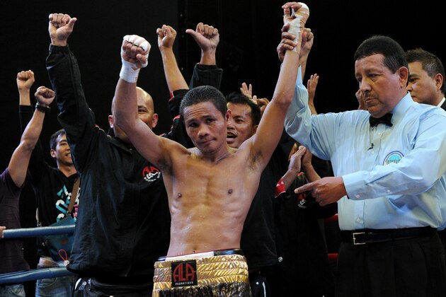 World Boxing Organization light-flyweight champion Donnie Nietes (C) of the Philippines celebrates after defeating Mexican challenger Felipe Salguero on June 2, 2012 during a WBO light-flyweight title bout in Manila, retaining his title.               AFP PHOTO / Jay DIRECTO        (Photo credit should read JAY DIRECTO/AFP/GettyImages)