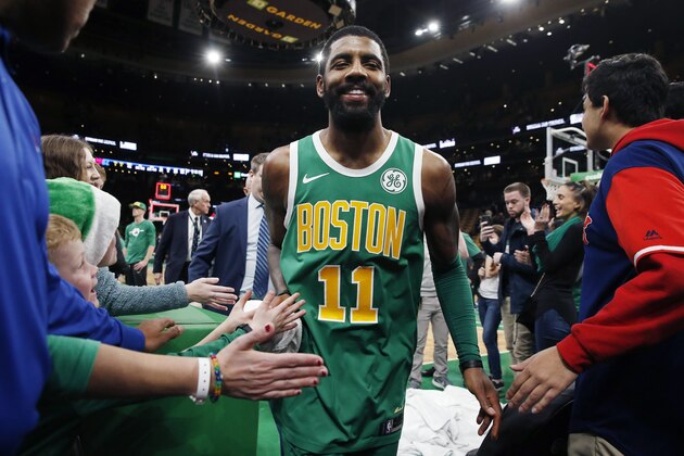 Boston Celtics' Kyrie Irving walks off the court after the Celtics defeated the Philadelphia 76ers 121-114  in overtime during an NBA basketball game in Boston, Tuesday, Dec. 25, 2018. (AP Photo/Michael Dwyer)