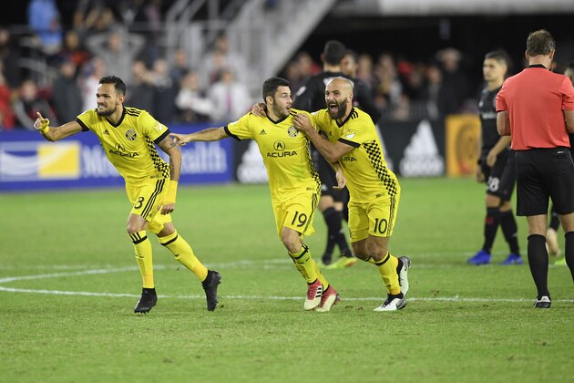 Columbus Crew SC midfielder Artur (8), Milton Valenzuela (19) and forward Federico Higuain (10) celebrate after penalty kicks in an MLS playoff soccer match against the D.C. United, Thursday, Nov. 1, 2018, in Washington. The Crew SC won 2-2 (3-2) in penalty kicks. (AP Photo/Nick Wass)