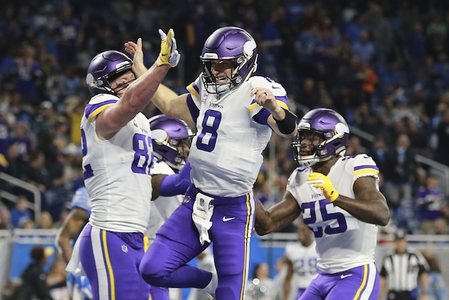 Minnesota Vikings quarterback Kirk Cousins (8) celebrates his 44-yard pass to tight end Kyle Rudolph, left, for a touchdown with no time on the clock during the first half of an NFL football game against the Detroit Lions, Sunday, Dec. 23, 2018, in Detroit. (AP Photo/Rey Del Rio)