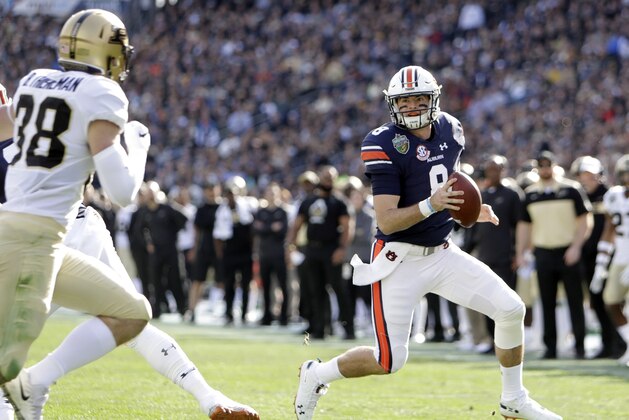 Auburn quarterback Jarrett Stidham (8) scrambles from Purdue safety Brennan Thieneman (38) in the first half of the Music City Bowl NCAA college football game Friday, Dec. 28, 2018, in Nashville, Tenn. (AP Photo/Mark Humphrey)