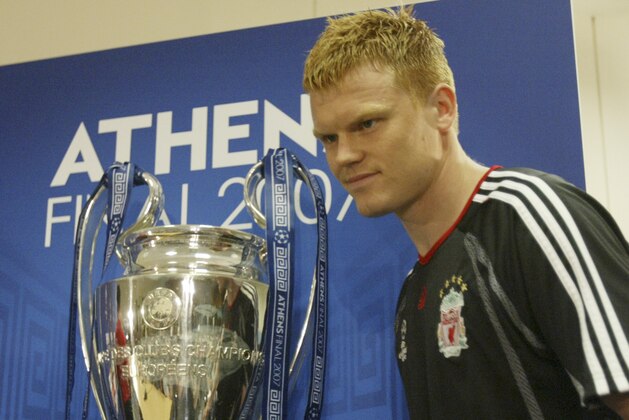 Liverpool soccer team player John Arne Riise walks past the Champions League trophy for a press conference at the Olympic Stadium in Athens, Tuesday May 22, 2007. Liverpool will face Italian team AC Milan in the final of the Champions League in Athens on Wednesday.  (AP Photo/Thanassis Stavrakis)