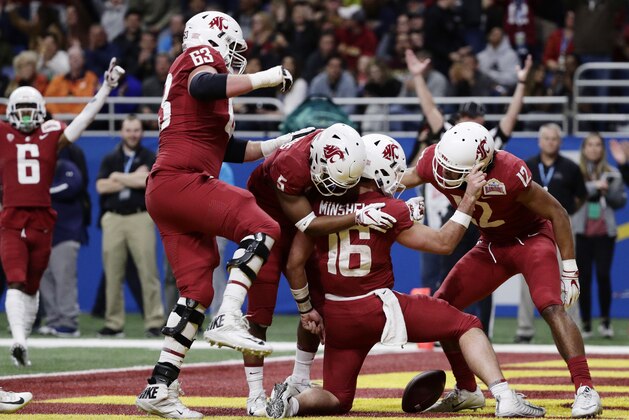 Washington State quarterback Gardner Minshew (16) celebrates with teammates after he scored a touchdown against Iowa State during the the first half of the Alamo Bowl NCAA college football game, Friday, Dec. 28, 2018, in San Antonio. (AP Photo/Eric Gay)