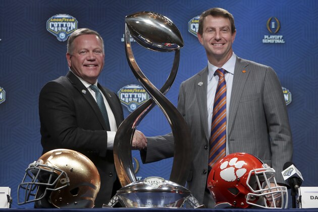 Notre Dame head coach Brian Kelly, left, and Clemson head coach Dabo Swinney share a moment during the NCAA Cotton Bowl football coaches' news conference in Dallas, Friday, Dec. 28, 2018. Notre Dame is scheduled to play Clemson in the NCAA Cotton Bowl semi-final playoff Saturday. (AP Photo/LM Otero)