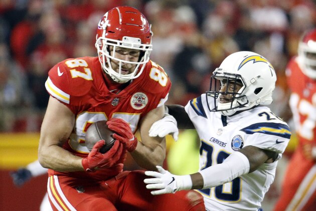 Kansas City Chiefs tight end Travis Kelce (87) makes a catch against Los Angeles Chargers cornerback Casey Hayward (26) during the second half of an NFL football game in Kansas City, Mo., Thursday, Dec. 13, 2018. (AP Photo/Charlie Riedel)