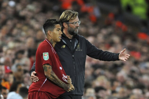 Liverpool manager Juergen Klopp, right, gives instructions to Roberto Firmino during the English League Cup soccer match between Liverpool and Chelsea at Anfield stadium in Liverpool, England, Wednesday, Sept. 26, 2018. (AP Photo/Rui Vieira)