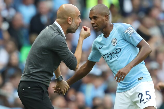 Manchester City's Spanish manager Pep Guardiola speaks with Manchester City's Brazilian midfielder Fernandinho during the English Premier League football match between Manchester City and Newcastle United at the Etihad Stadium in Manchester, north west England, on September 1, 2018. (Photo by Lindsey PARNABY / AFP) / RESTRICTED TO EDITORIAL USE. No use with unauthorized audio, video, data, fixture lists, club/league logos or 'live' services. Online in-match use limited to 120 images. An additional 40 images may be used in extra time. No video emulation. Social media in-match use limited to 120 images. An additional 40 images may be used in extra time. No use in betting publications, games or single club/league/player publications. /         (Photo credit should read LINDSEY PARNABY/AFP/Getty Images)