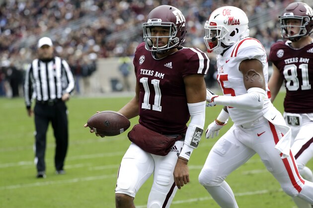 Texas A&M quarterback Kellen Mond (11) rushes for a touchdown as Mississippi Rebels defensive back Myles Hartsfield (15) defends during the first half of an NCAA college football game Saturday, Nov. 10, 2018, in College Station, Texas. (AP Photo/David J. Phillip)