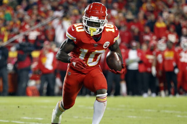 Kansas City Chiefs wide receiver Tyreek Hill (10) runs with the ball during the first half of an NFL football game against the Los Angeles Chargers in Kansas City, Mo., Thursday, Dec. 13, 2018. (AP Photo/Charlie Riedel)