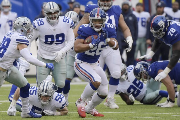 New York Giants' Saquon Barkley (26) runs the ball during the first half of an NFL football game against the Dallas Cowboys, Sunday, Dec., 30, 2018, in East Rutherford, N.J. (AP Photo/Bill Kostroun)
