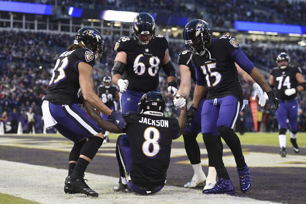 Teammates lift Baltimore Ravens quarterback Lamar Jackson after he scored a touchdown in the first half of an NFL football game against the Cleveland Browns, Sunday, Dec. 30, 2018, in Baltimore. (AP Photo/Gail Burton)
