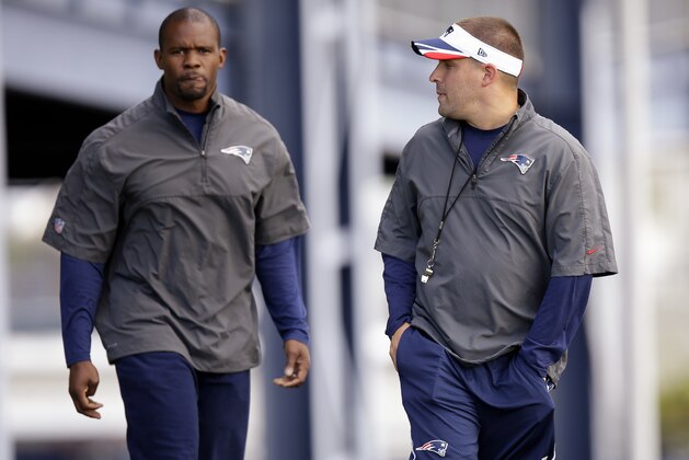 FILE - In this Oct. 8, 2014, file photo, New England Patriots offensive coordinator Josh McDaniels, right, talks with safety's coach Brian Flores as they walk out to the field before practice begins at the NFL football team's facility in Foxborough, Mass. It looked like the Patriots would be replacing both of their coordinators following February's Super Bowl loss to Philadelphia. McDaniels walked away from a deal to coach the Colts. But there will be a new look on defense, with Flores taking over play calling duties following defensive coordinator Matt Patricia's departure. AP Photo/Stephan Savoia, File)