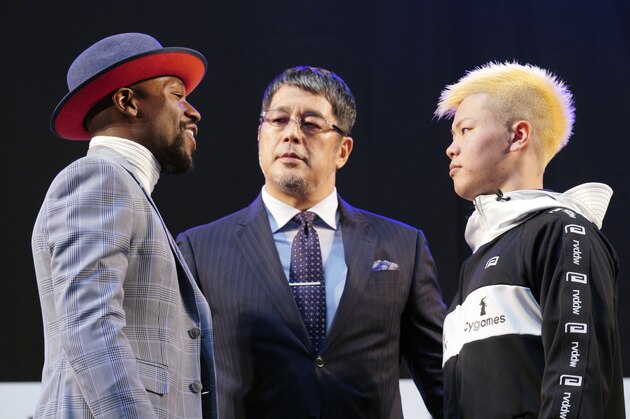 Floyd Mayweather Jr., left, and Japanese kickboxer Tenshin Nasukawa, right, face each other after their official weigh-in ceremony at Saitama Super Arena in Saitama, north of Tokyo Sunday, Dec. 30, 2018. Mayweather is scheduled to fight in a three-round exhibition match in Japan on New Year's Eve. (AP Photo/Eugene Hoshiko)