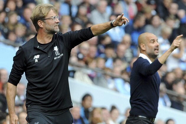 Manchester City's coach Pep Guardiola, right, and Liverpool's coach Juergen Klopp, left, gesture during the English Premier League soccer match between Manchester City and Liverpool at the Etihad Stadium in Manchester, England, Saturday, Sept. 9, 2017. (AP Photo/Rui Vieira)