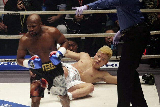 Japanese kickboxer Tenshin Nasukawa lies on the mat after being knocked out by Floyd Mayweather Jr. during first round of their three-round exhibition match on New Year's Eve, at Saitama Super Arena in Saitama, north of Tokyo, Monday, Dec. 31, 2018. (AP Photo/Koji Sasahara)