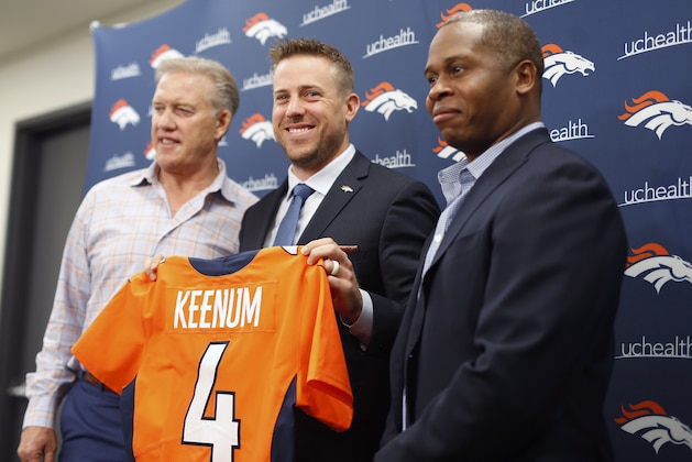 Case Keenum, center, smiles as he holds up his new jersey as John Elway, left, general manager of the Denver Broncos, and head coach Vance Joseph look on during a news conference to introduce Keenum as the new starting quarterback of the team at the organization's headquarters Friday, March 16, 2018, in Englewood, Colo. (AP Photo/David Zalubowski)