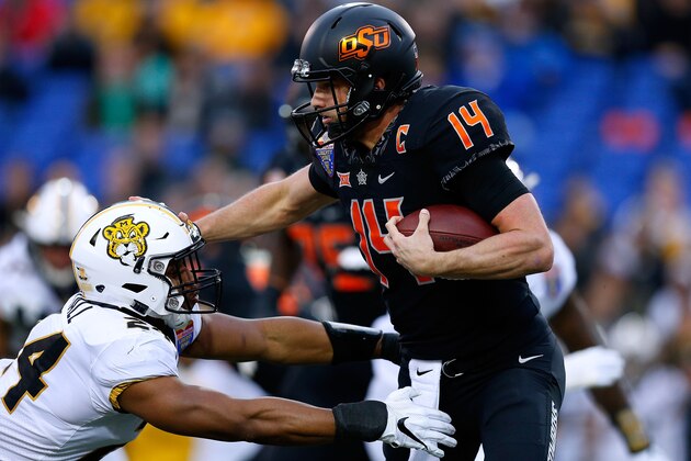 MEMPHIS, TENNESSEE - DECEMBER 31: Taylor Cornelius #14 of the Oklahoma State Cowboys runs with the ball as Terez Hall #24 of the Missouri Tigers defends during the first half of the AutoZone Liberty Bowl at Liberty Bowl Memorial Stadium on December 31, 2018 in Memphis, Tennessee. (Photo by Jonathan Bachman/Getty Images)