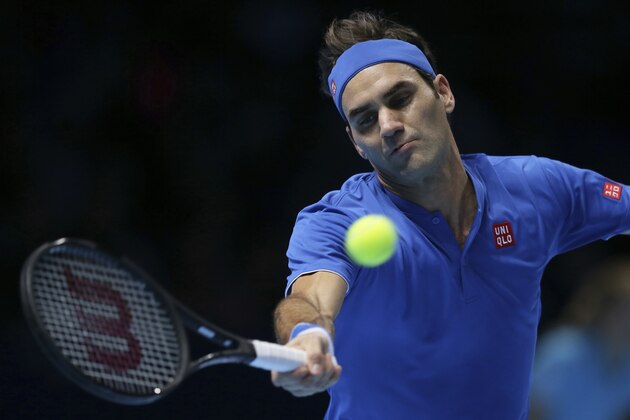 Roger Federer of Switzerland plays a return to Alexander Zverev of Germany in their ATP World Tour Finals singles tennis match at the O2 Arena in London, Saturday Nov. 17, 2018. (AP Photo/Tim Ireland)