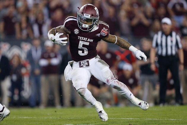 JACKSONVILLE, FL - DECEMBER 31:  Trayveon Williams #5 of the Texas A&M Aggies runs for a touchdown against the North Carolina State Wolfpack during the first half of the TaxSlayer Gator Bowl at TIAA Bank Field on December 31, 2018 in Jacksonville, Florida.  (Photo by Michael Reaves/Getty Images)